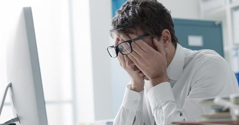 Stressed office worker sitting in front of computer
